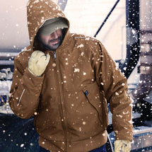 Man wearing saddle Rubicon jacket standing outside working in the snow.