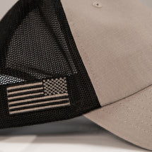 Detail shot of rope range trucker hat side view featuring American flag