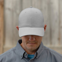 Man wearing grey Titan Hat looking down