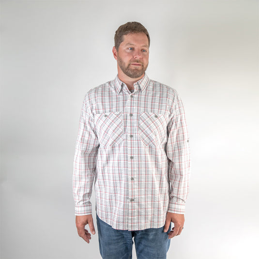 Man wearing grey and white plaid Highridge Seersucker shirt while standing inside 