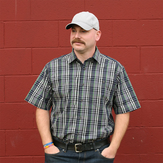 Man wearing black District Plaid shirt while standing outside