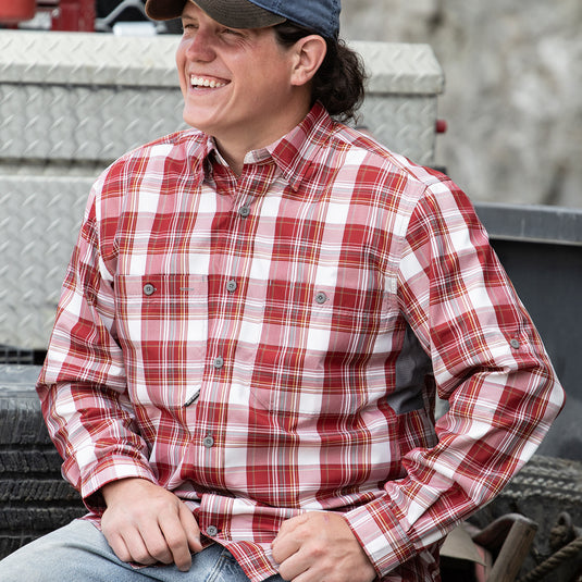 Man wearing red and white Highridge Plaid shirt while sitting in truck bed