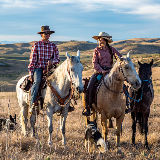 Man wearing red and while Highridge Plaid Shirt while riding horse
