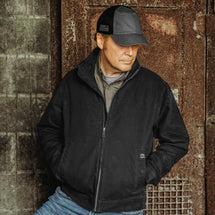 Man wearing black Maverick Work Jacket outdoors.