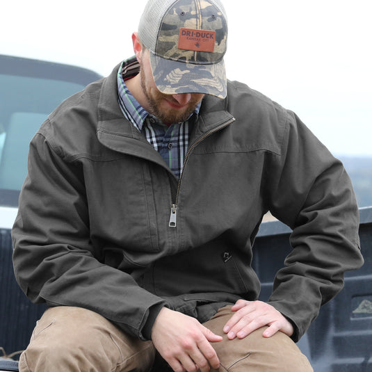 Man wearing charcoal Force Bomber sitting in truck bed