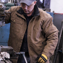 Man wearing Field Khaki Endeavor Canvas Jacket while standing outside.