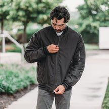 Man wearing charcoal Rogue Canvas Jacket while walking outside
