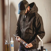 Man wearing tobacco Laredo while working indoors