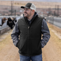 Man wearing black Rigor Work Vest standing outside