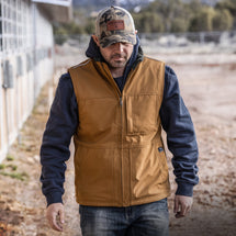 Man wearing saddle Rigor Work Vest walking outside