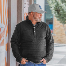 Man wearing black Keystone jacket standing outside with hands in pocket
