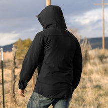 Man wearing black Apex jacket walking away