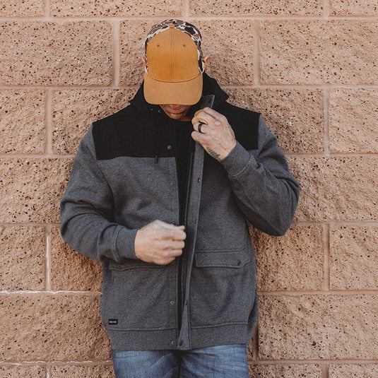 Man wearing dark oxford Crosstech Full-Zip Hoodie while zipping up jacket