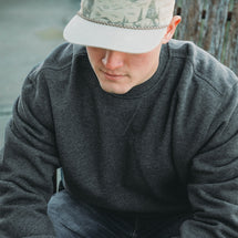 Man wearing dark oxford Granite Crewneck while sitting outside