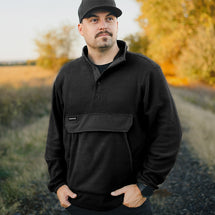 Man wearing black Timber Men's Fleece Pullover jacket standing outside