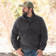 Man wearing charcoal Timber Men's Fleece Pullover standing outside