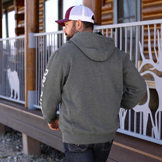 Man wearing dark oxford DRI DUCK Sleeve Woodland Fleece Hoodie while walking away