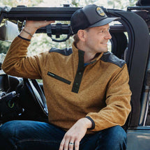 Man wearing saddle Ranger Men's Fleece Pullover while sitting in car.