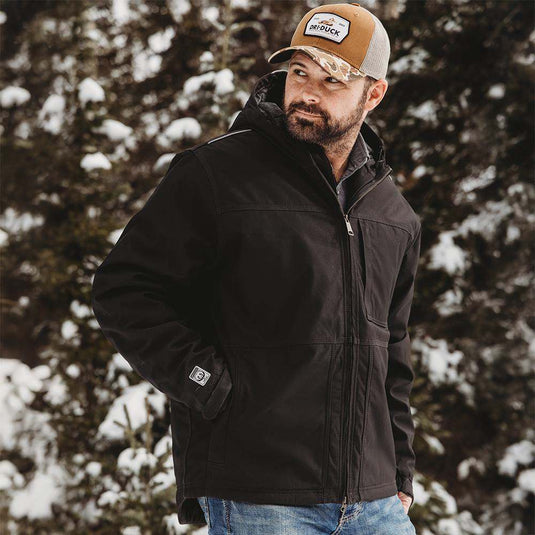 Man wearing black Kodiak Work Jacket while working outside.